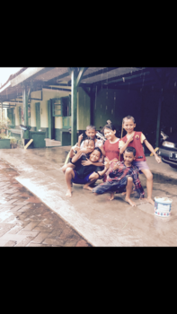 Surabaya - Indonesian kids playing happily in the rain, Surabaya ( East Java )