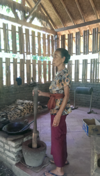 Bali - Balinese woman makes coffee in a traditional way